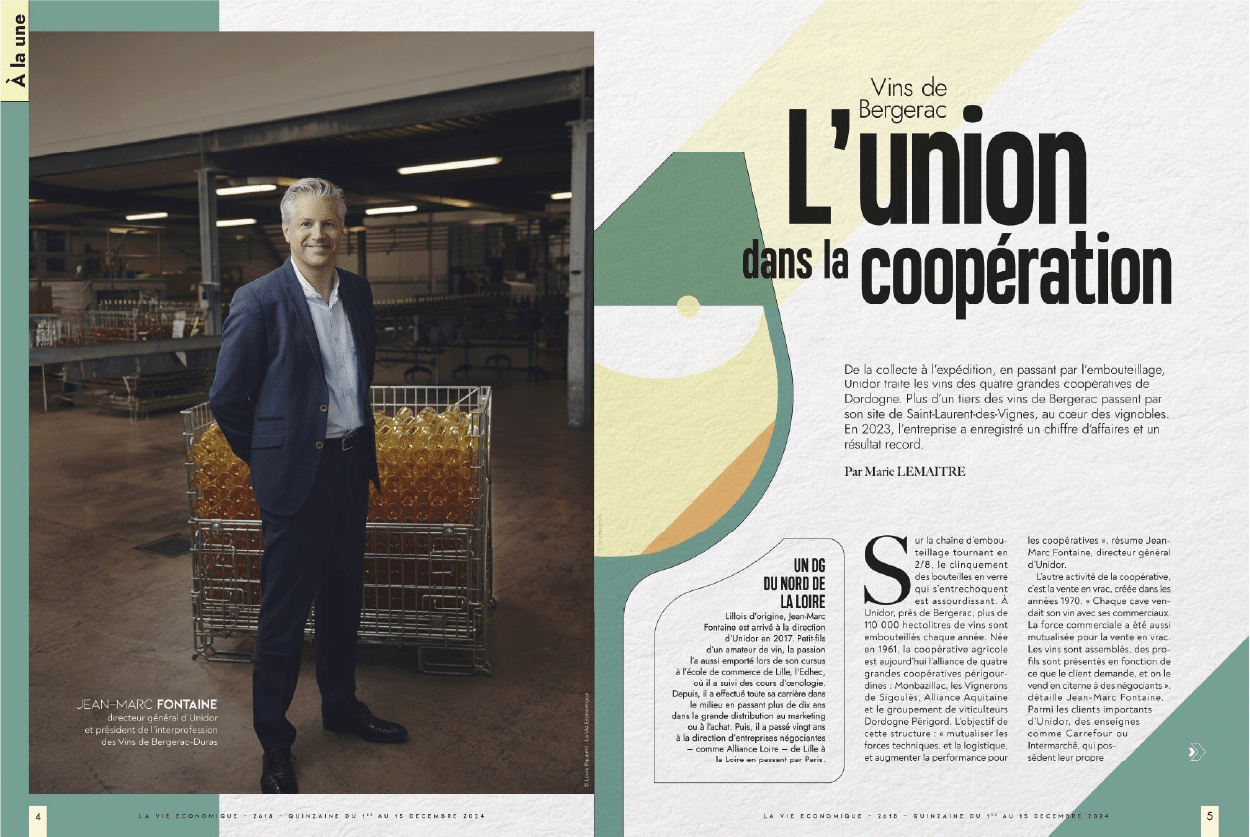 Jean-Marc Fontaine, directeur général d'Unidor, souriant devant des casiers de bouteilles de Vins de Bergerac, article sur l'union dans la coopération.